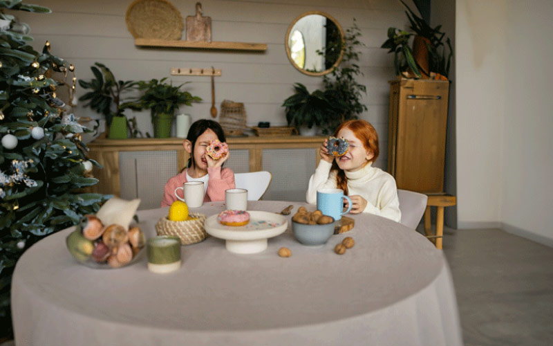 a young family enjoying afternoon tea, afternoon tea, August 2024, UK