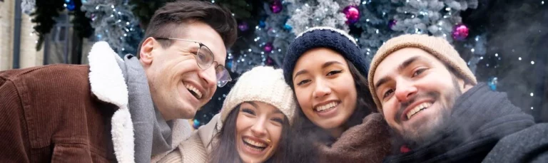 Families enjoying Alton Towers Winter Breaks with festive lights in the background, alton Towers Merlin Breaks