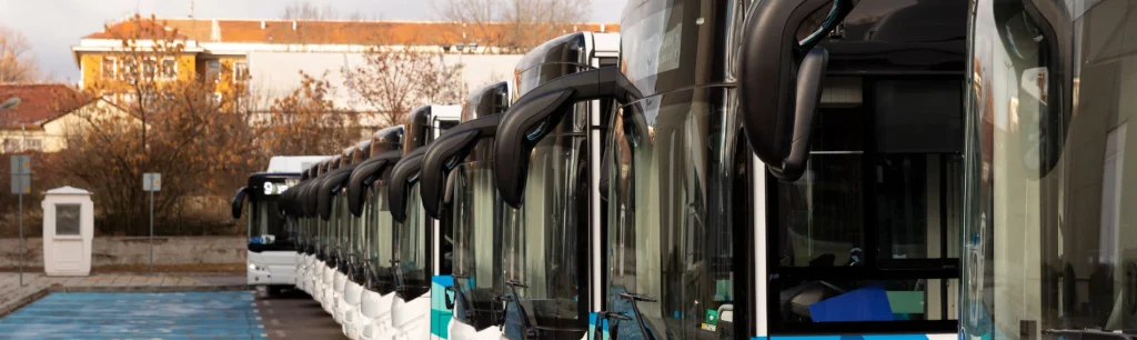 Modern charter bus parked outside corporate office in Birmingham, charter bus transportation