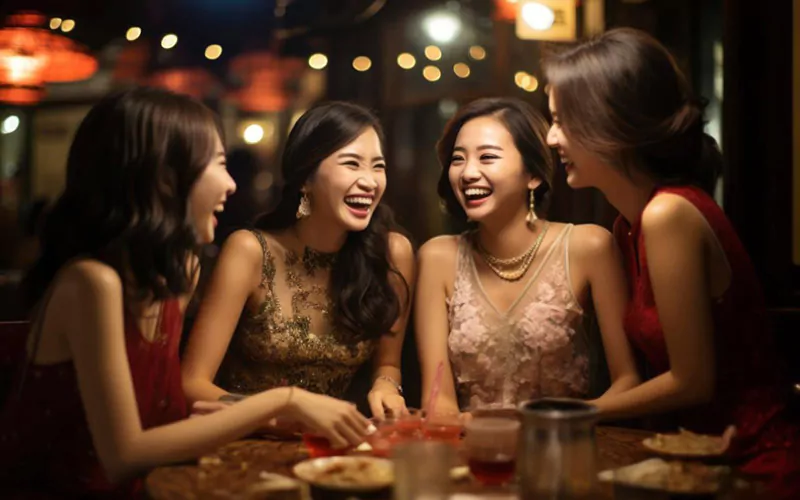 women enjoying dinner together, Birmingham group transport, December 2024, UK